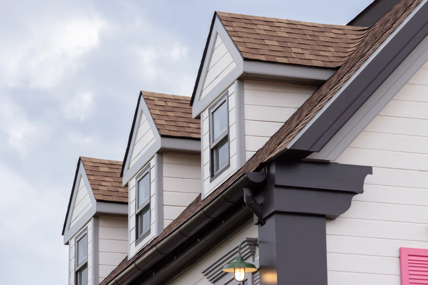 Asphalt shingles on a a house with a slanted roof installed by Brinkmann Quality Roofing, who also install metal roofs in Houston.