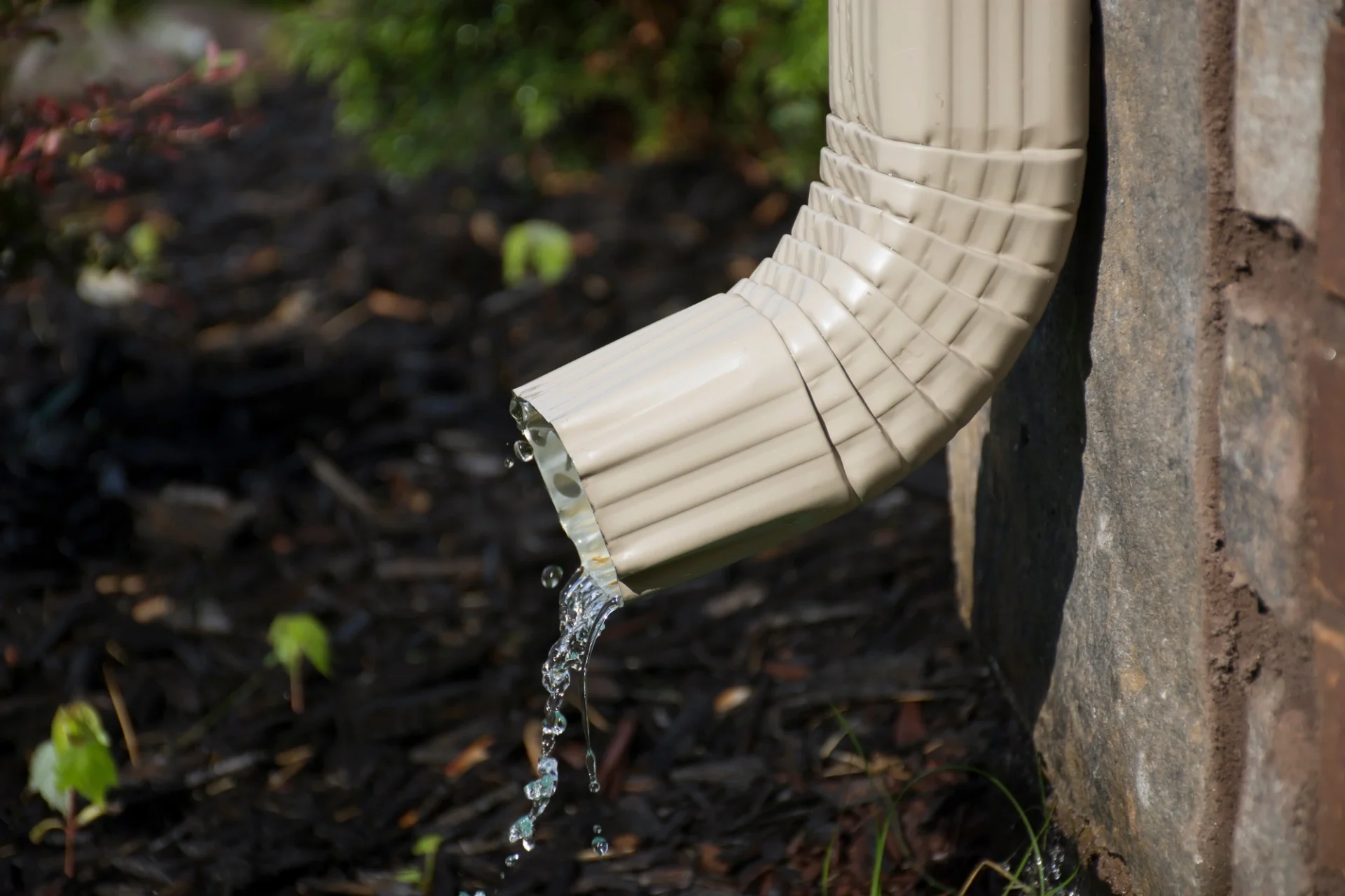 Downspout of Katy, TX home’s gutter system maintained by Brinkmann Roofing