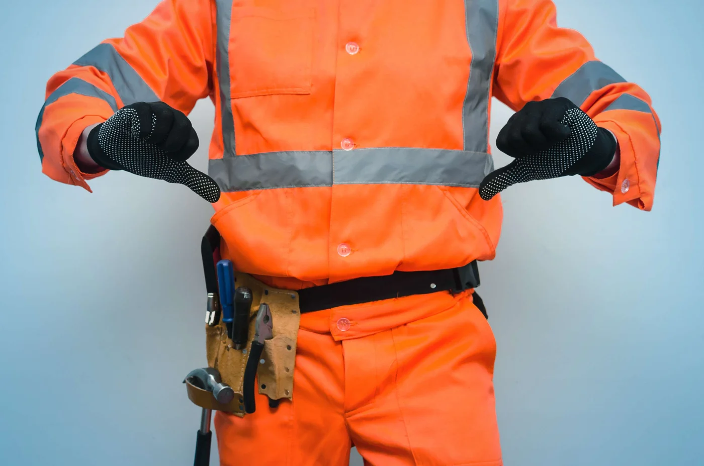 Roofer dressed in orange with two thumbs down to indicate dissatisfaction