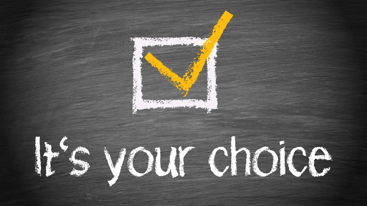 Close view of a chalkboard with the words “It’s Your Choice” written below a box filled in with a checkmark