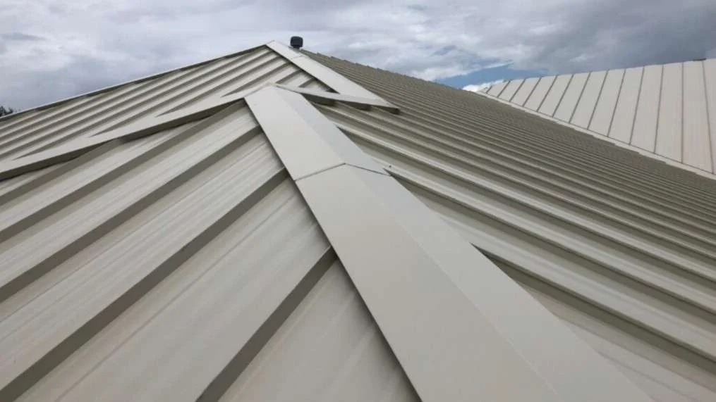 Expert Metal Roof Replacement Houston Area Brinkmann Quality Roofing Close view of the connection point between the planes of a Houston-area metal roof replacement