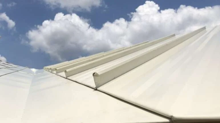 Close view up one of the valleys of a Brinkmann standing-seam metal roof replacement