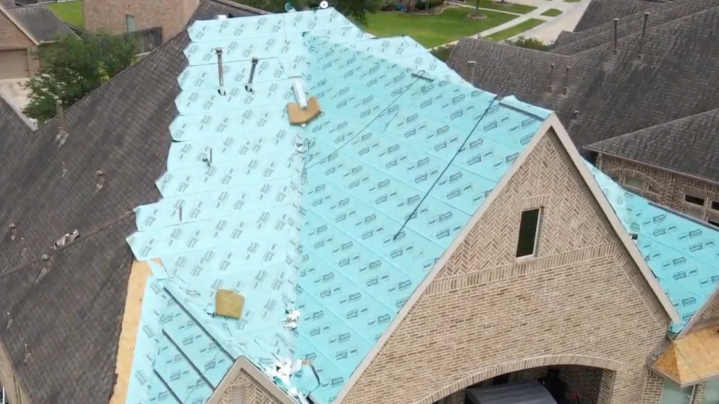 Strong Fortified Roofing Systems in Friendswood, TX | Brinkmann Quality Roofing Services A brick house with fortified roofing being installed in the Houston Area.