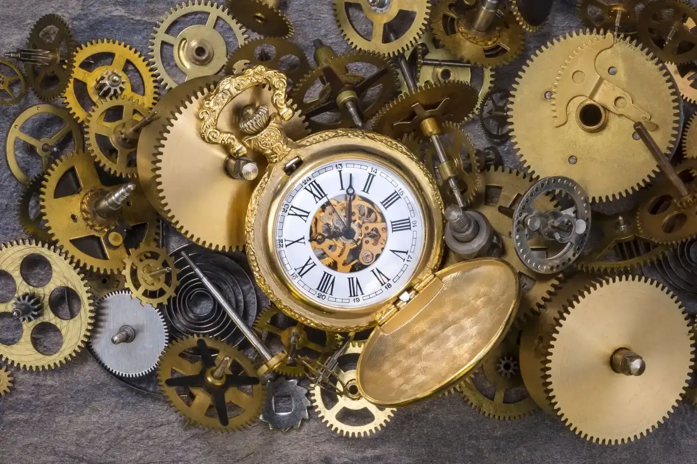 Efficient Commercial Roofing in the Houston Area by Brinkmann Quality Roofing Services A close-up of clock gears and an antique pocket watch in the center.