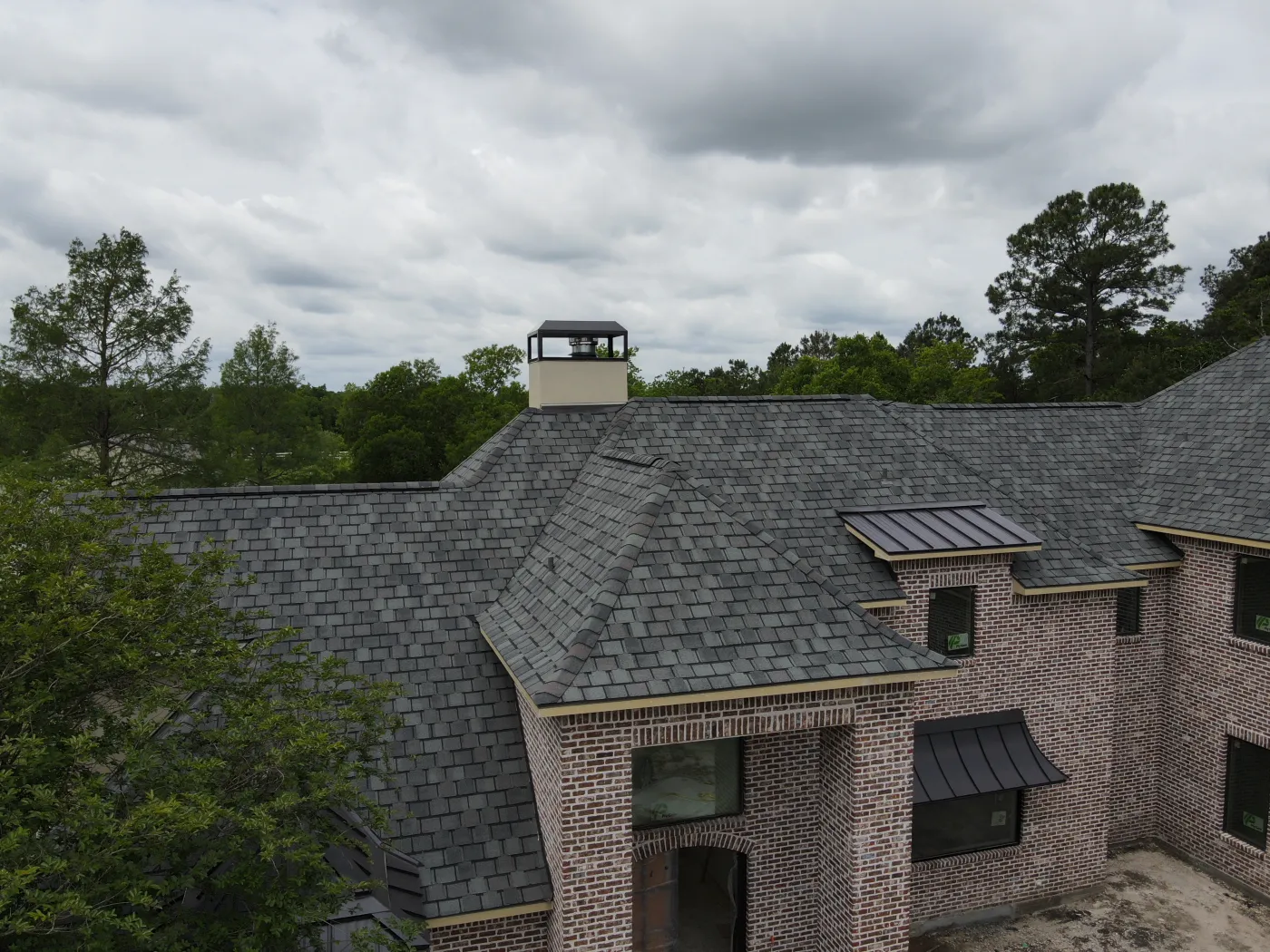 Certainteed Belmont Colonial Slate roof installation metal accents dark bronze standing seam roofing professionals in friendswood tx