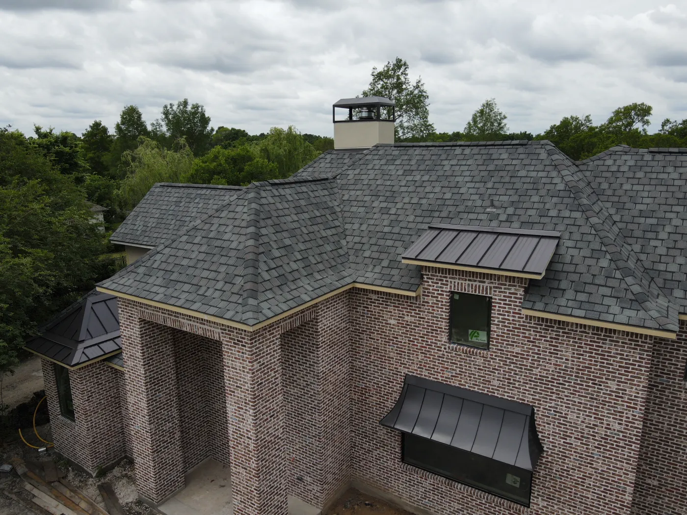 Roof replacement with Certainteed Belmont Colonial Slate metal roof accents dark bronze cobra ridgevent pearland TX