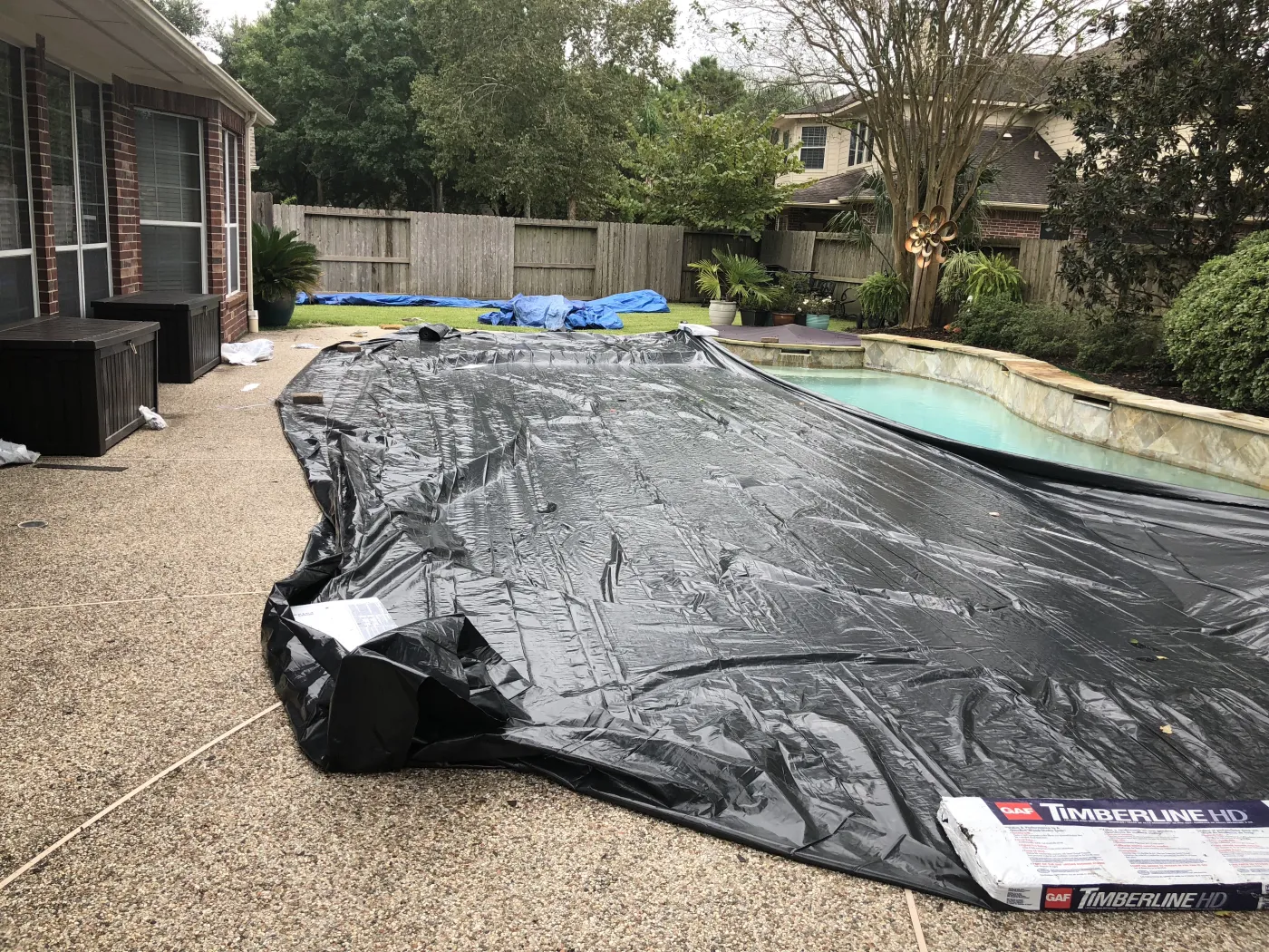 cover pool during roof replacement by professional roofer master elite brinkmann difference clear lake tx
