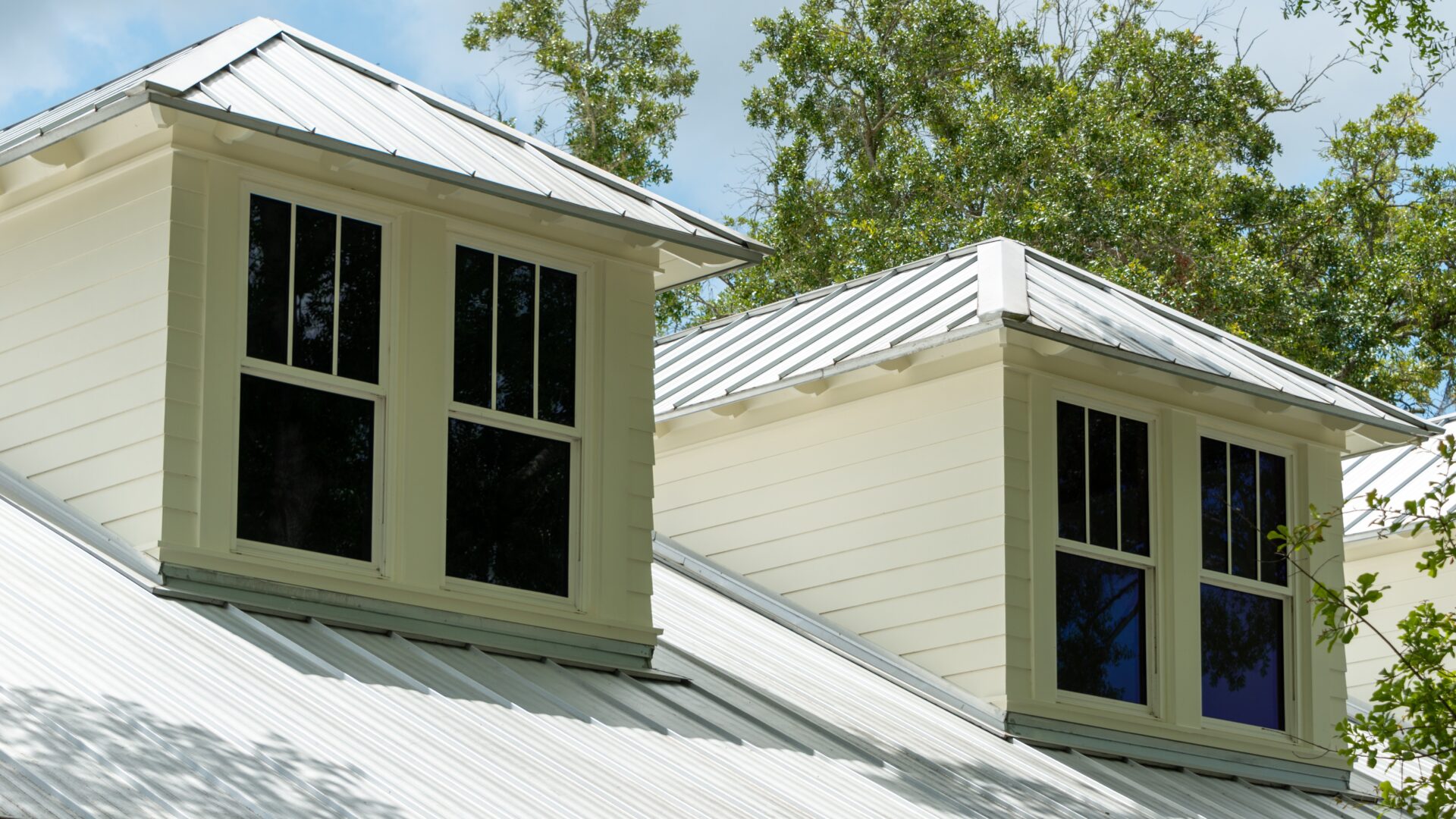 Two dormers with gray metal roofing