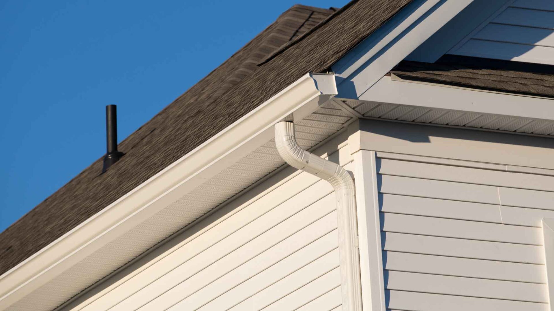 View of the endcap and downspout of a seamless gutter system