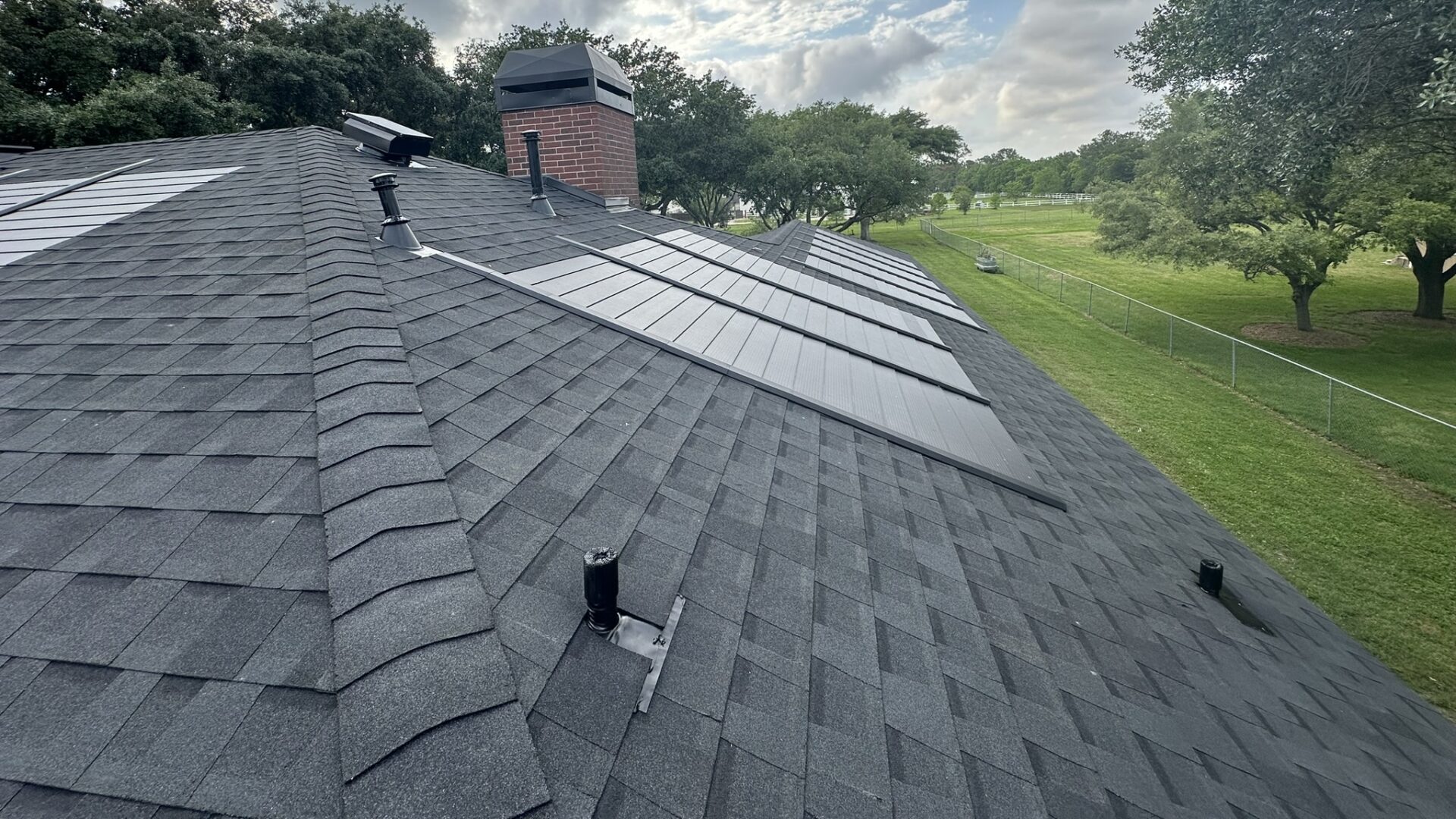 GAF solar shingles installed on a gray shingle roof