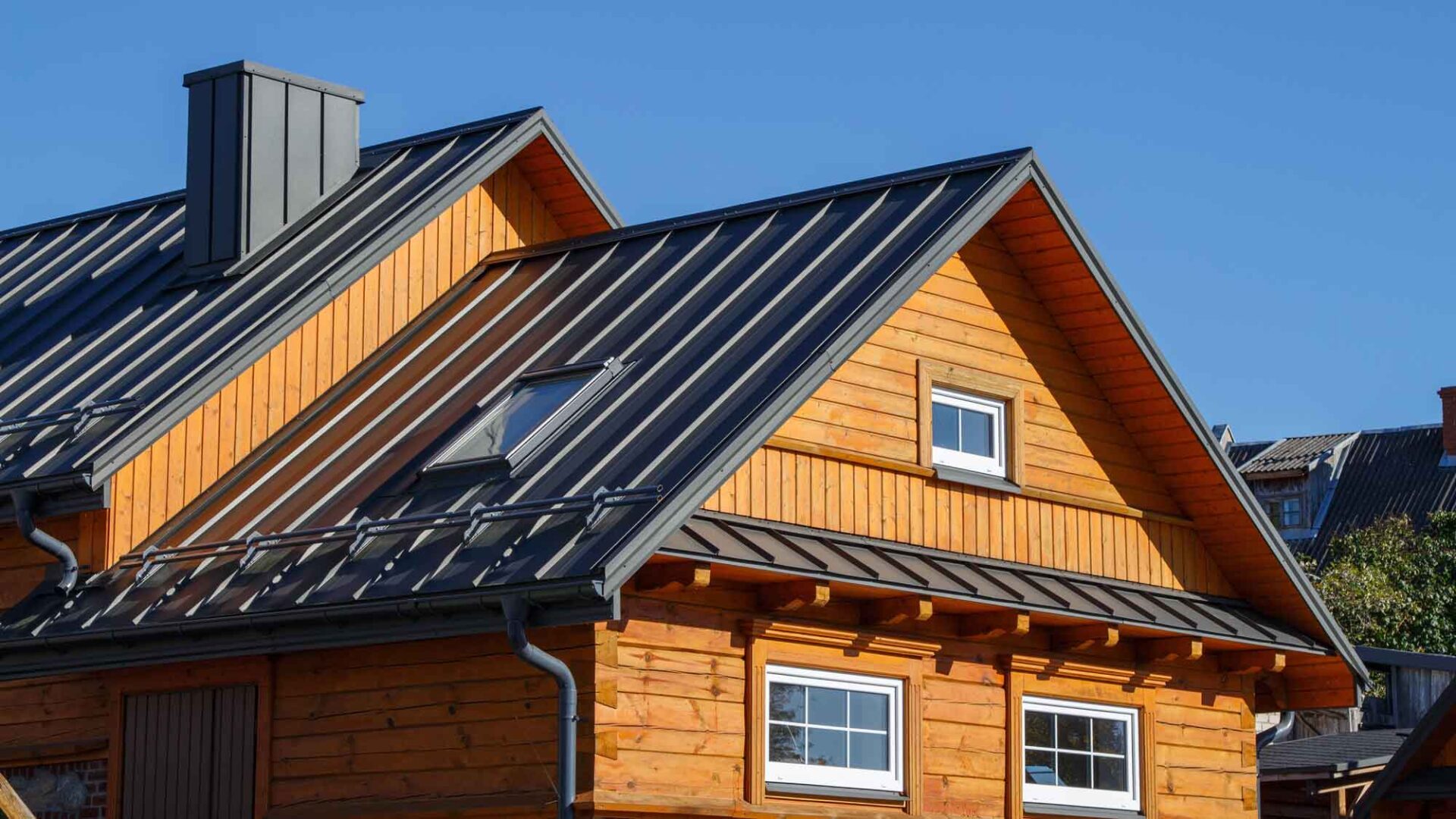 A wood-sided home with a metal roof